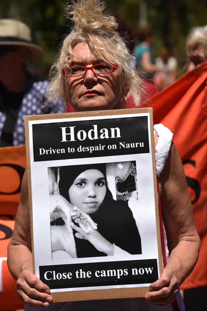 An activist in Sydney holds a placard in an event organized by Doctors for Refugees to demand humane treatment of asylum seekers and refugees.