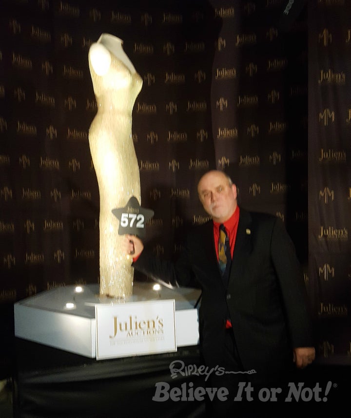 Ripley's Edward Meyer poses next to the dress Marilyn Monroe wore when she sang at President John F. Kennedy's birthday.