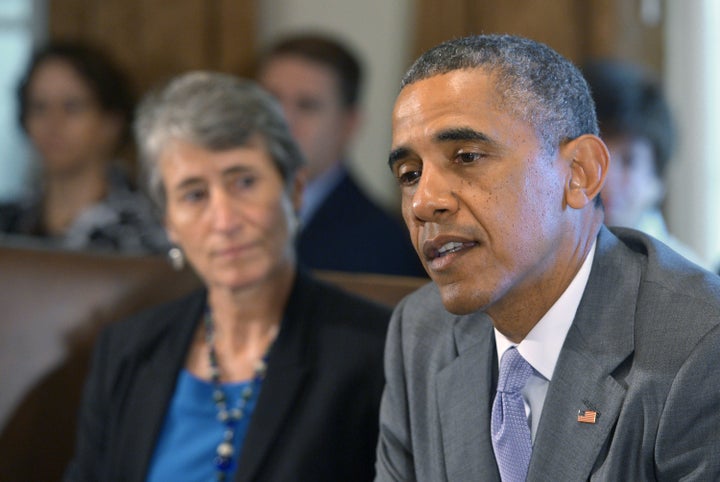 President Barack Obama sits next to Interior Secretary Sally Jewell during a 2014 cabinet meeting.