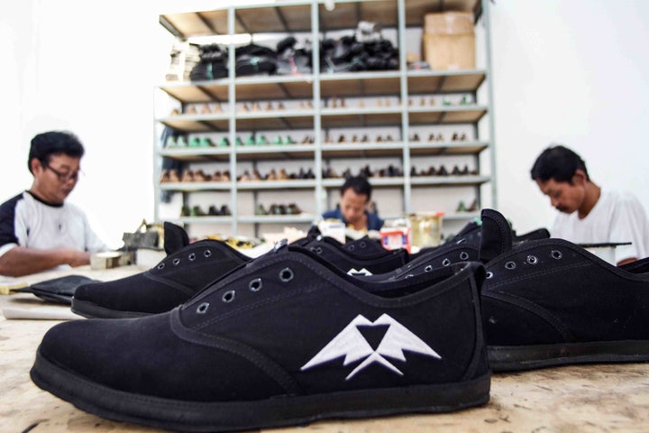 Artisans handcrafting the uppers of the “JJ” lace-up shoe.