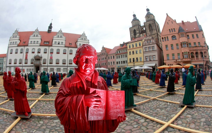 Plastic statuettes of 16th-century Protestant reformer Martin Luther, part of the art installation 'Martin Luther - I'm standing here' by German artist Ottmar Hoerl, are pictured in the main square in Wittenberg, eastern Germany August 11, 2010.