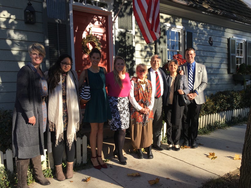 Ahmed gathers with his team, including author Patrick Burnett (far-right), and gracious hosts in front of the home of The Rev