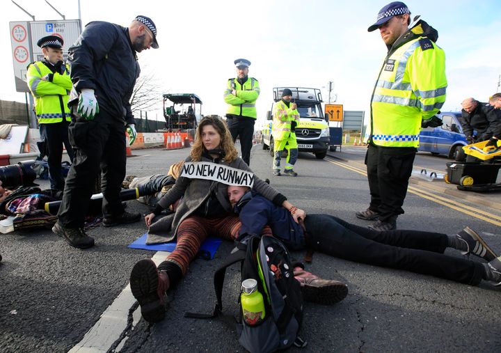 Environmental protestors block a road during a protest near Heathrow airport in west London that led to 15 arrests