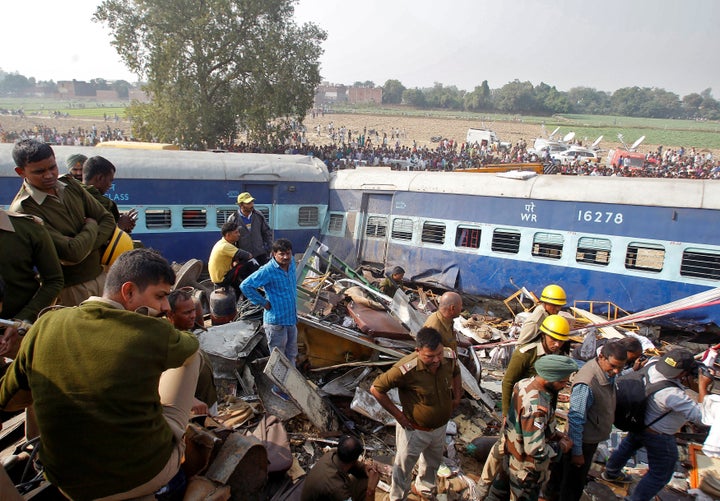 Rescue workers search for survivors at the site of a train derailment in Pukhrayan, south of Kanpur city, India November 20,