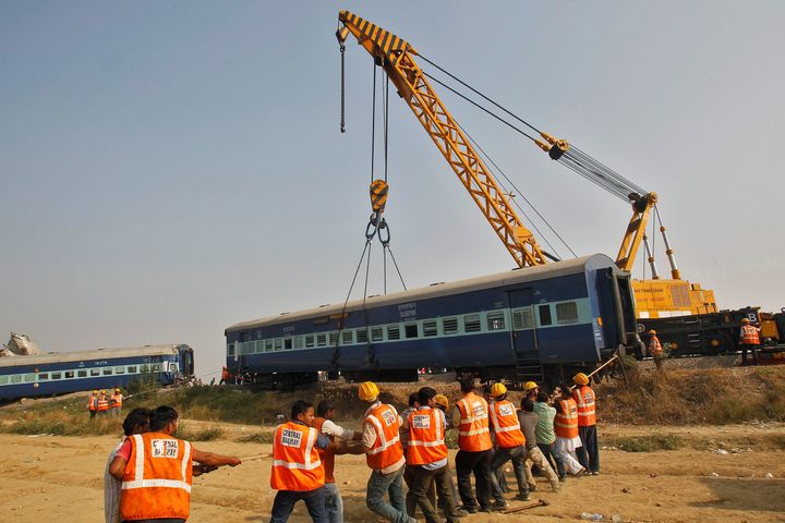 Rescue workers search for survivors at the site of a train derailment in Pukhrayan, south of Kanpur city, India November 20, 2016.