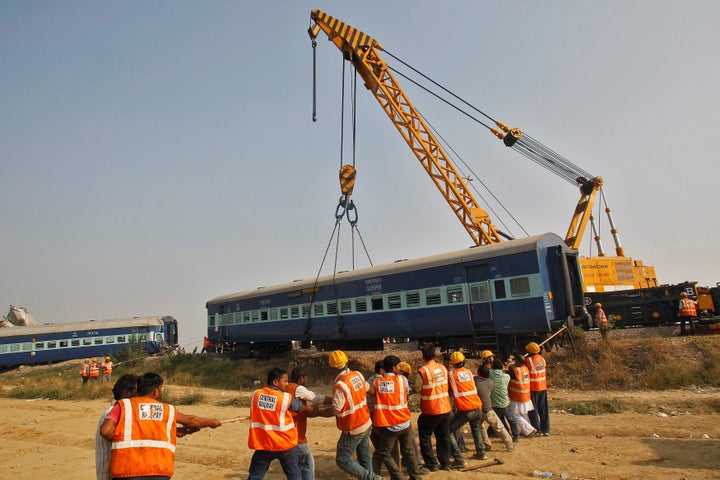 Rescue workers search for survivors at the site of a train derailment in Pukhrayan, south of Kanpur city, India November 20,