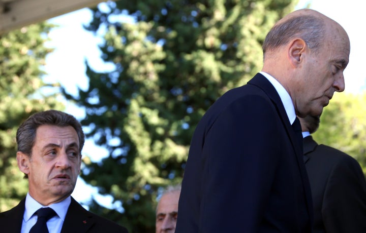 Former President Nicolas Sarkozy (L) and politician Alain Juppe, both candidates for the conservative presidential primary.