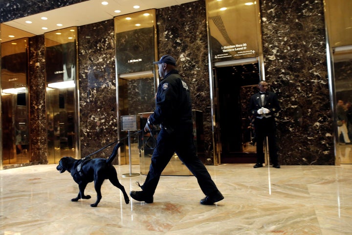 Security has been beefed up at the swanky skyscraper since Donald Trump was elected president. A police officer and K-9 are seen patrolling the building's lobby on Friday.