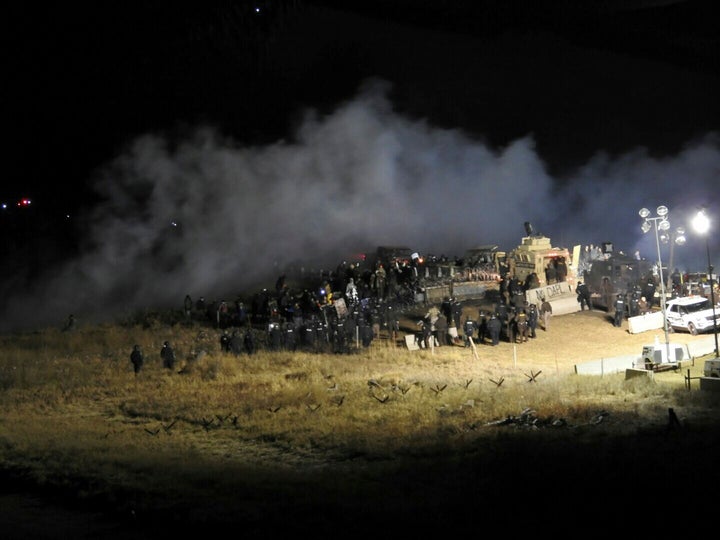 Law enforcement officers surrounded demonstrators protesting the Dakota Access pipeline in North Dakota on Sunday night.