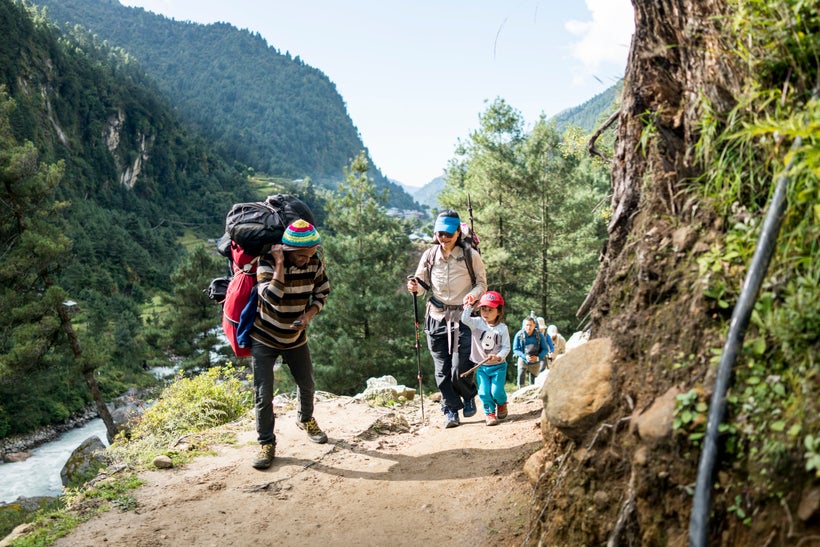 <em>A porter greets Little Chow on the trek towards Namche Bazaar, at an altitude of 10,000ft..</em>