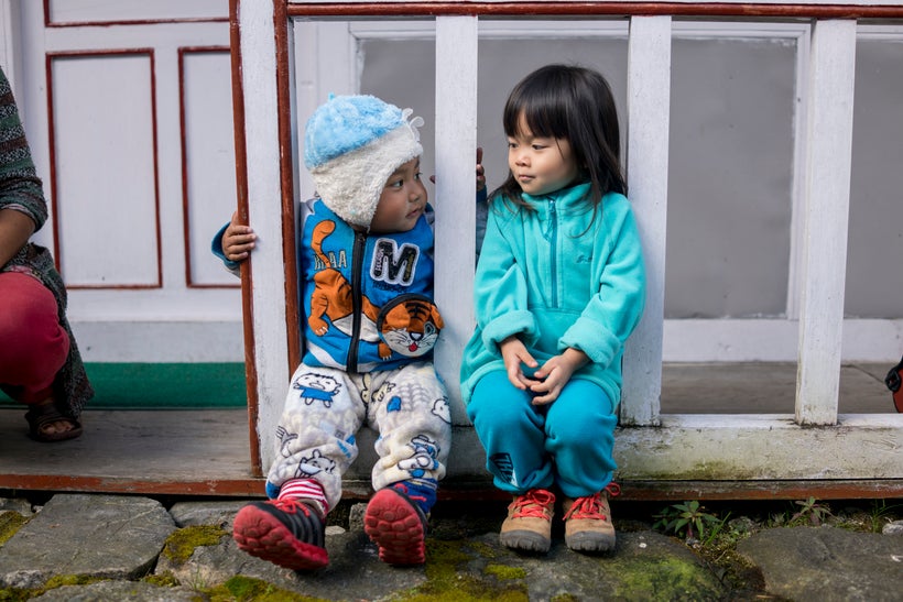 <em>Little Chow cosies up to a fellow local toddler.</em>