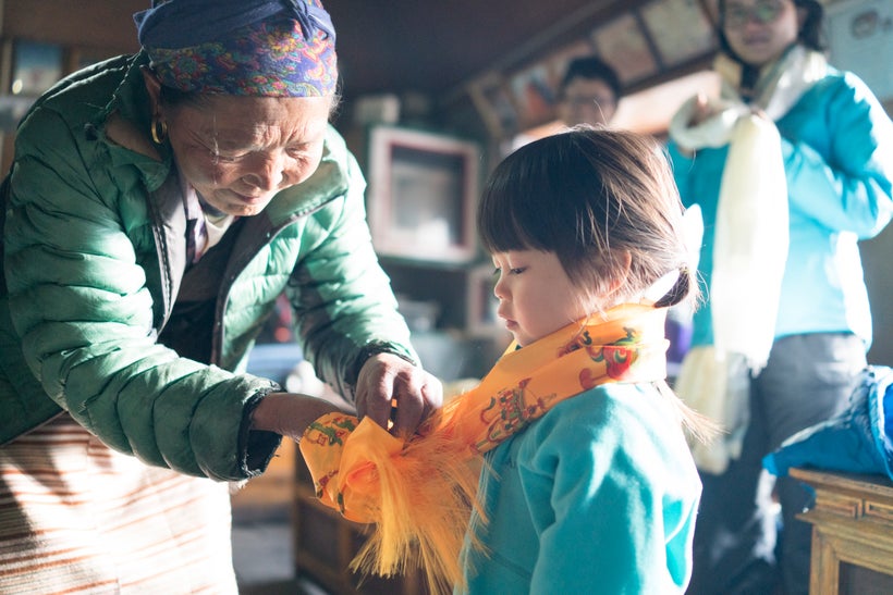 <em>Lakpa Diki, 60 puts on a kata for Little Chow as a Sherpa custom of blessing for a safe passage home. Little Chow have e