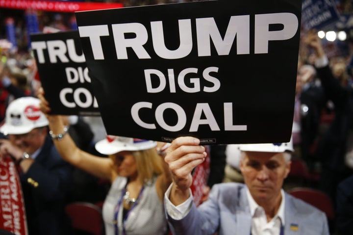 A delegate holds a sign reading 'Trump Digs Coal' during the Republican National Convention in July.