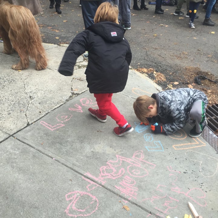 Chrystin Ondersma's 7-year-old son and his friend attended the anti-hate rally at Adam Yauch Park and wrote messages on the sidewalk like "peace" and "hate is bad."