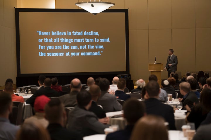 Supporters view an inspirational quote following a video presentation at a conference hosted by the white nationalist group N