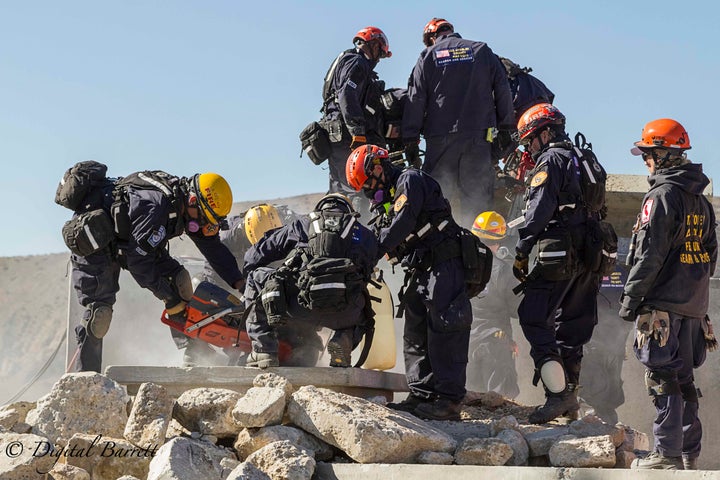 <p>Rescue crews cut through concrete to reach victims</p>