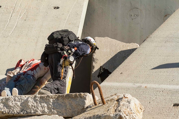 <p>Kino showing his handler Chuck Wong where the first victim is buried in the rubble pile at the Del Valle Regional Training Facility</p>