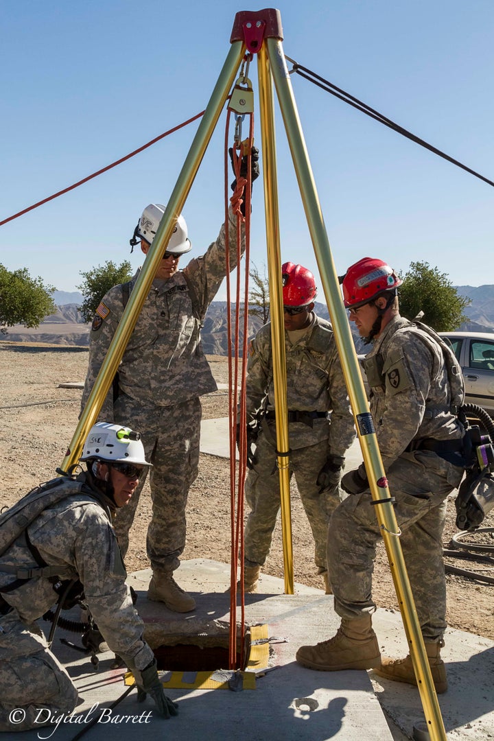 <p>California National Guard members prepare to raise a victim from an underground pipe system, meant to simulate people trapped underground</p>