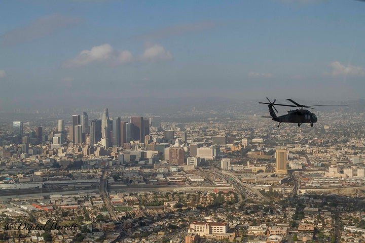 <p>A UH-60 Blackhawk piloted by the California Army National Guard makes its way around downtown Los Angeles </p>
