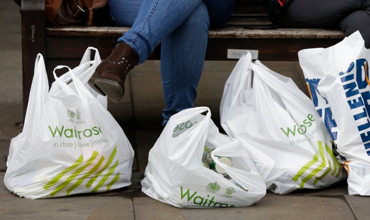 The number of plastic carrier bags found on UK beaches has dropped by almost half since the introduction of a 5p charge