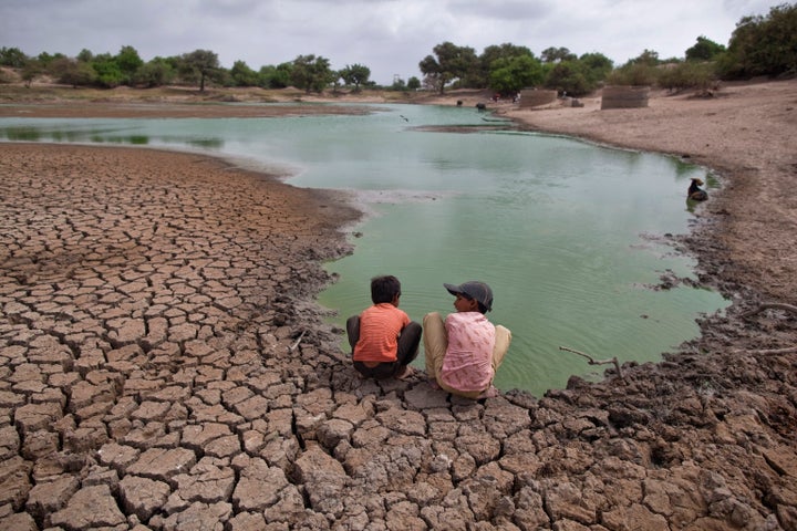Children wash their hands in a partially dried-out natural pond at Badarganj village, in the western Indian state of Gujarat in August 2012.