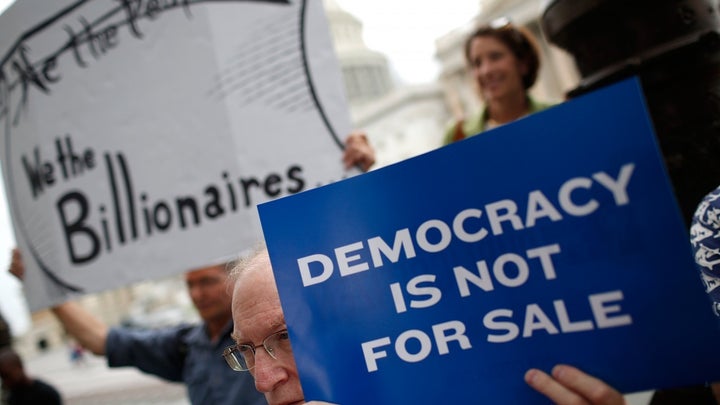 <p>Supporters of campaign finance reform protest outside the United States Capitol.</p>