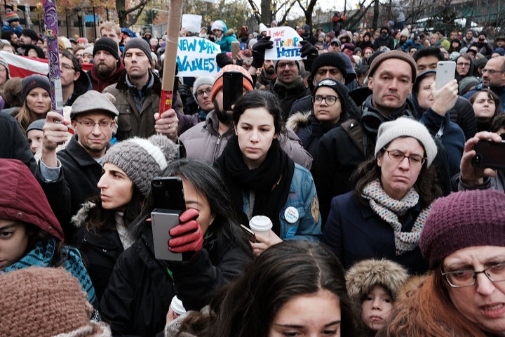 People participate in an anti-hate rally on Nov. 20 at a Brooklyn park named in memory of late Beastie Boys band member Adam Yauch after it was defaced with swastikas.