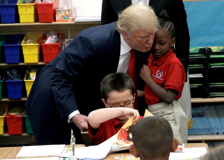 President-elect Donald Trump hugs a student after receiving a Bible as a gift during a campaign visit to the International Church of Las Vegas and the International Christian Academy.