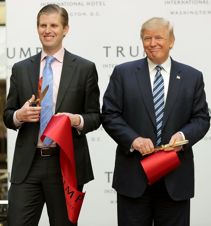 President-elect Donald Trump (right) and his adult son Eric Trump (left) cut the ribbon to open the Trump International Hotel in Washington, D.C.