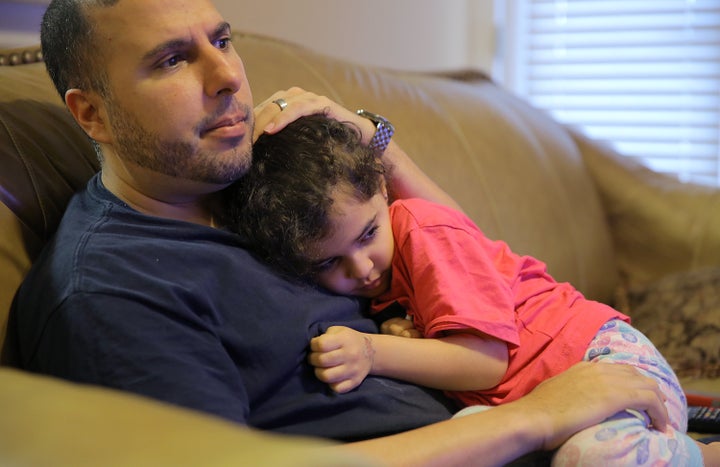 North Carolina resident Shadi Sadi holds his 5-year-old daughter Saja while watching the news at home on the morning after the election.