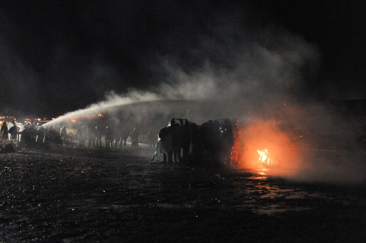 Law enforcement officers use a water cannon amid protests against the Dakota Access Pipeline.