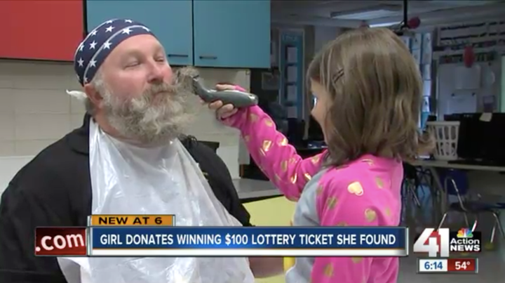 The second-grader got the first shot at helping shave her gym teacher's beard as a fun prize for winning her school's food drive.