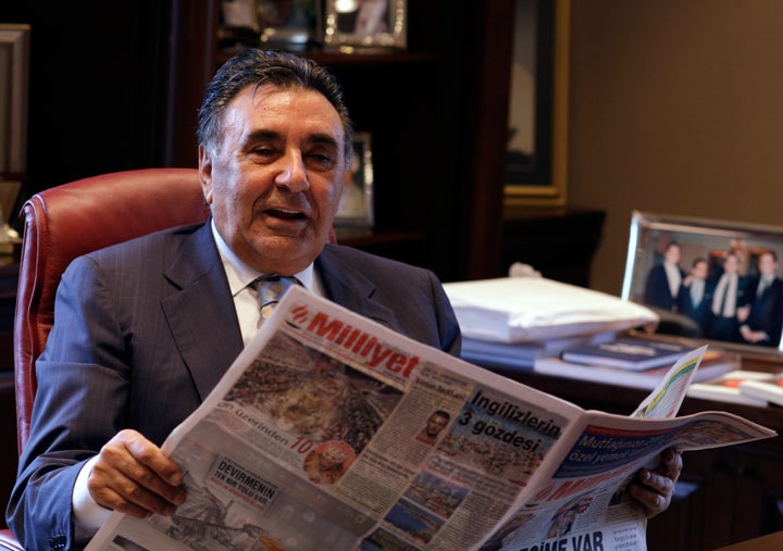 Aydin Dogan holds a copy of his daily newspaper Milliyet at his Istanbul office in 2009. His Dogan Media Group properties have been pressured by the Erdogan government.