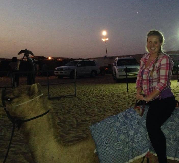 Me riding a camel during a cultural excursion in the UAE desert. 