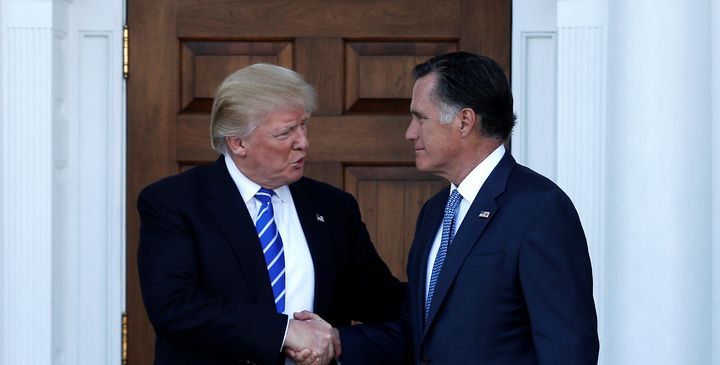 U.S. President-elect Donald Trump (L) shakes hands with former Massachusetts Governor Mitt Romney after their meeting at the main clubhouse at Trump National Golf Club in Bedminster, New Jersey, U.S., November 19, 2016.