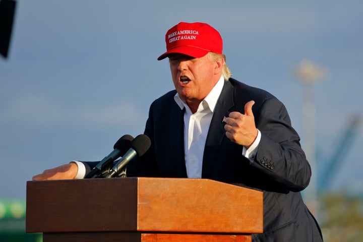 Donald Trump gives the thumbs up while wearing his campaign hat promising to 'Make America Great Again'