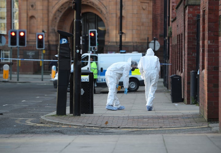 <strong>Forensic police outside Manchester College, where two teenagers were stabbed on Thursday </strong>