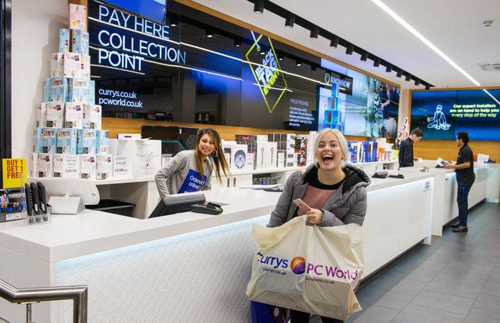 A customer buys a camera at Currys PC World during Black Friday, the biggest retail event of the year on Oxford Street, London