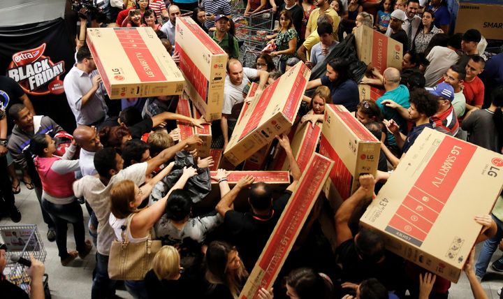 How it should be done: Shoppers reach for television sets as they compete to purchase retail items on Black Friday at a store in Sao Paulo, Brazil