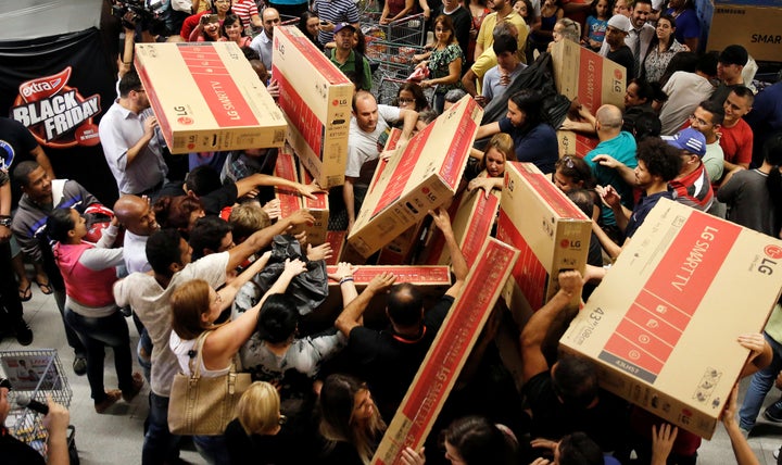 How it should be done: Shoppers reach for television sets as they compete to purchase retail items on Black Friday at a store in Sao Paulo, Brazil