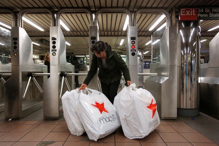<strong>A shopperenters the subway carrying purchases from Macy's Herald Square store during the Black Friday sales in New York</strong>
