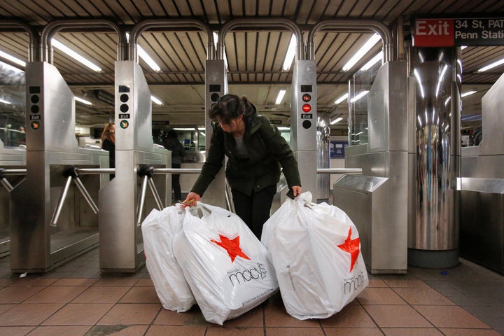 A shopperenters the subway carrying purchases from Macy's Herald Square store during the Black Friday sales in New York