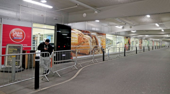 A single person at the front of the queue at the Tesco Extra store in Manchester, waits for the start of their Black Friday Sale