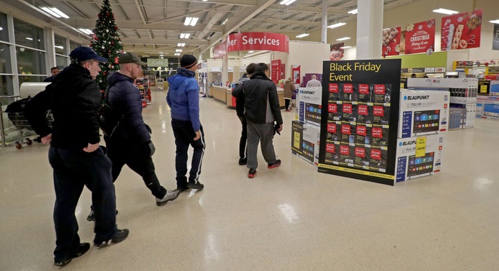 Shoppers enter the Tesco Extra store in Manchester, looking for cheap deals at the start of the supermarket's Black Friday sale