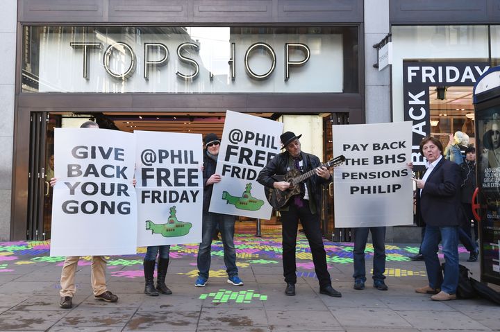 Protesters let by musician Homesick Mick (third right) outside Topshop in Oxford Circus, London, demonstrate against Sir Philip Green.