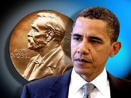 President Barack Obama next to a large Nobel Peace Prize Medal plate