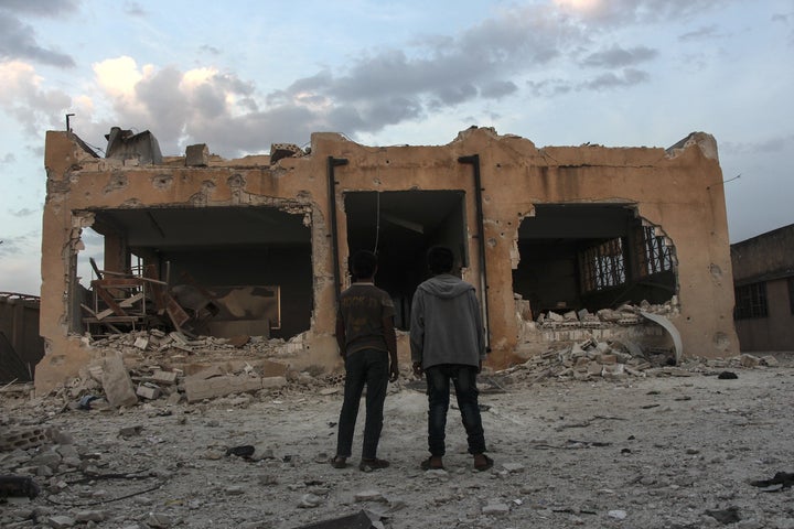 Syrians inspect the school in Haas that was destroyed by an Oct. 26 airstrike.