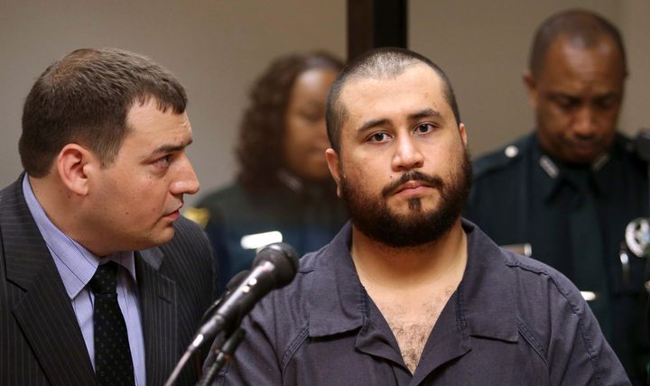George Zimmerman, right, the acquitted shooter in the death of Trayvon Martin, listens to defense counsel Daniel Megaro during his first-appearance hearing in Sanford, Florida, Nov. 19, 2013.