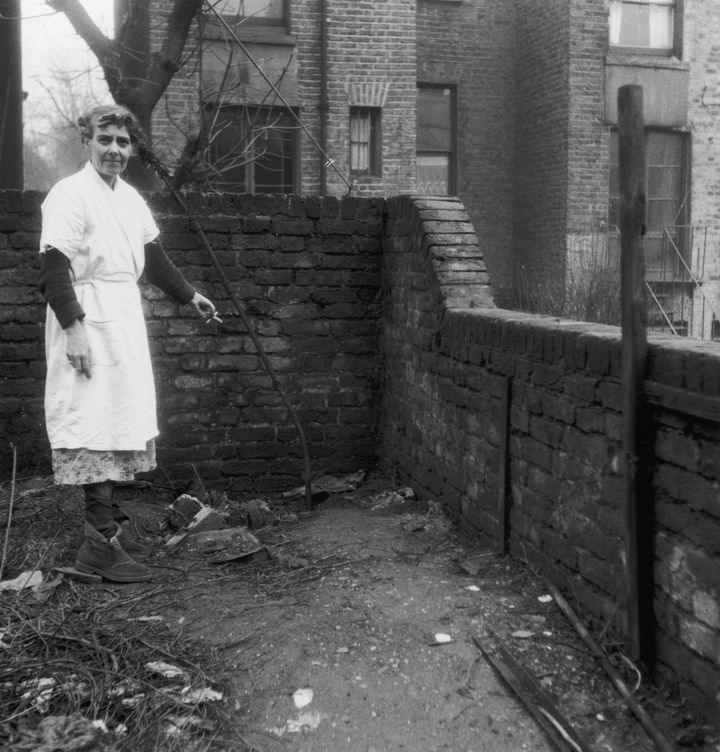 <strong>Christie's neighbour Mrs Hart, points to the spot in the garden of 10 Rillington Place, where two of his victims were buried (1953)</strong>