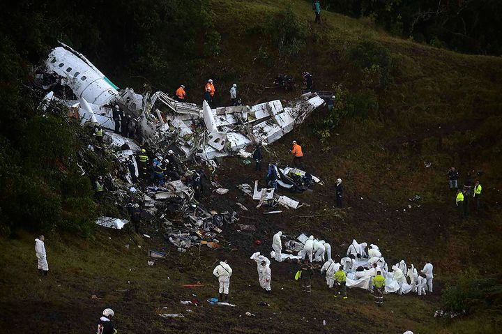 Rescuers search for survivors from the wreckage of the LAMIA airlines charter plane